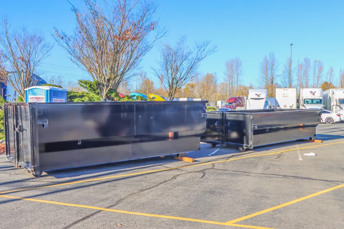 Professional dumpster rental service with roll-off container on residential driveway in Duanesburg